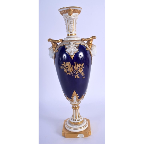 299 - Royal Worcester two handled vase with blue ground and child face masks, painted with fruit in a gilt... 