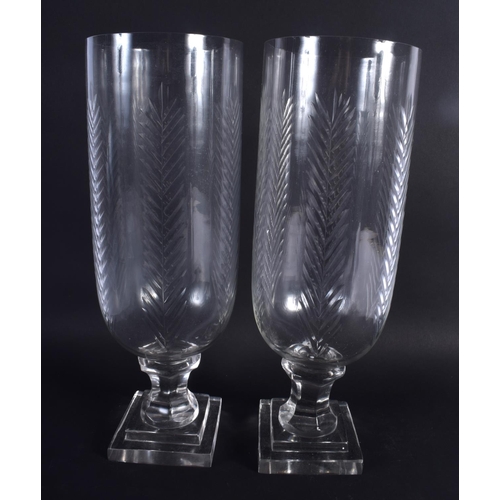 31 - A LARGE PAIR OF CUT GLASS STORM CELERY VASES. 34 cm high.