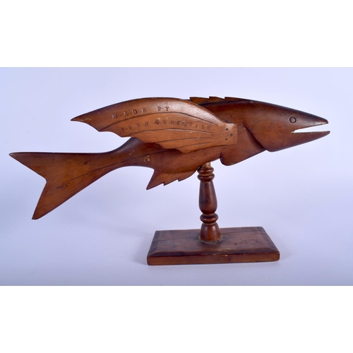 467 - A VINTAGE PITCAIRN ISLANDS FIGURE OF A FLYING FISH upon a rectangular plinth. 20 cm x 27 cm.