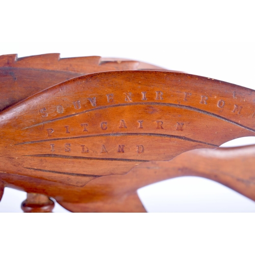 467 - A VINTAGE PITCAIRN ISLANDS FIGURE OF A FLYING FISH upon a rectangular plinth. 20 cm x 27 cm.