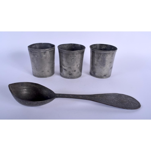 470 - THREE ANTIQUE PEWTER BEAKERS together with an early spoon. Largest 24.5 cm long. (4)