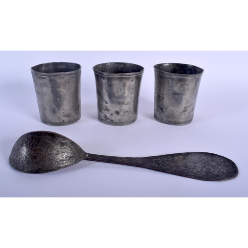 470 - THREE ANTIQUE PEWTER BEAKERS together with an early spoon. Largest 24.5 cm long. (4)