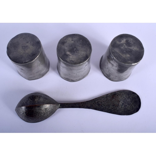 470 - THREE ANTIQUE PEWTER BEAKERS together with an early spoon. Largest 24.5 cm long. (4)