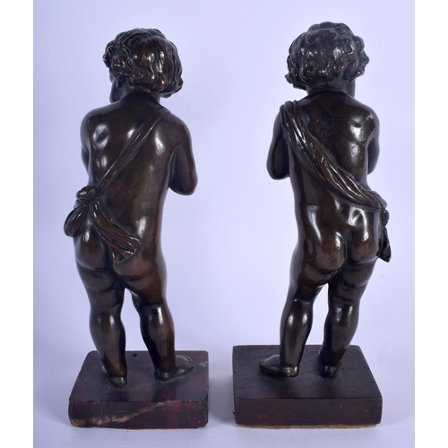 474 - A PAIR OF 19TH CENTURY EUROPEAN BRONZE FIGURES OF PUTTI modelled upon red marble bases. 21 cm high.