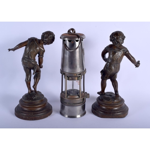 476 - A VINTAGE MINERS LAMP together with a pair of antique spelter figures. 30 cm high. (3)