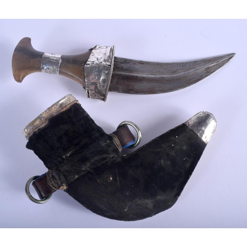 481 - A 19TH CENTURY MIDDLE EASTERN OMANI CARVED RHINOCEROS HORN HANDLED JAMBIYA DAGGER overlaid in silver... 