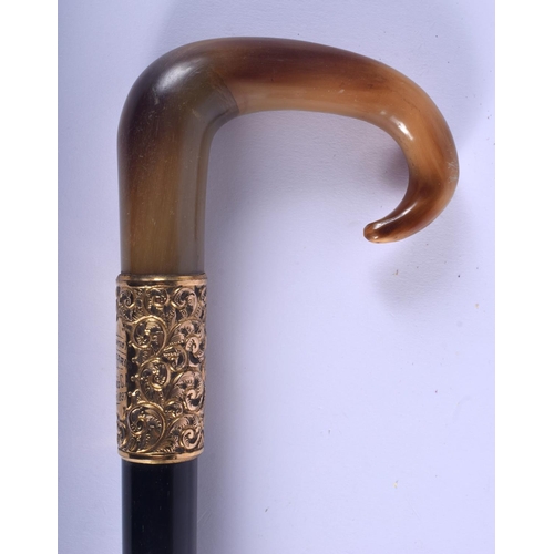 493 - A 19TH CENTURY CONTINENTAL CARVED BUFFALO HORN HANDLED WALKING CANE with yellow metal repousse handl... 