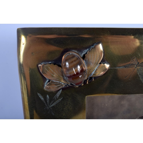 513 - AN AESTHETIC MOVEMENT BRASS AND AGATE PHOTOGRAPH FRAME inset with a nee, together with enamelled cop... 