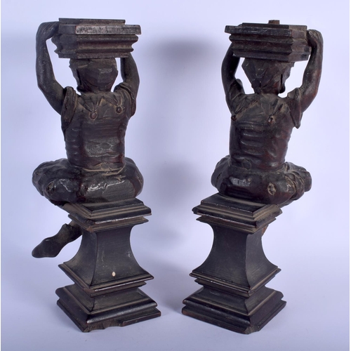 535 - A PAIR OF 19TH CENTURY NORTHERN EUROPEAN CARVED WOOD FIGURAL SUPPORTS modelled as figures with legs ... 