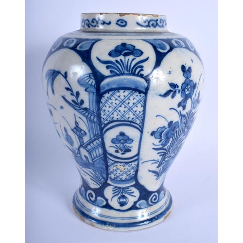 55 - AN 18TH CENTURY DUTCH DELFT BLUE AND WHITE BALUSTER VASE painted with floral sprays. 23 cm x 12 cm.