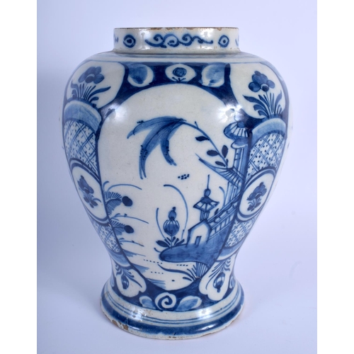 55 - AN 18TH CENTURY DUTCH DELFT BLUE AND WHITE BALUSTER VASE painted with floral sprays. 23 cm x 12 cm.