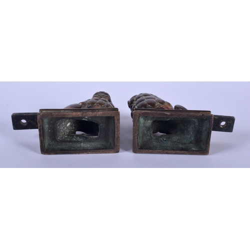 572 - A PAIR OF 18TH CENTURY EUROPEAN BRONZE LIONS together with a bronze carytaid mounts. 42 cm long. (3)