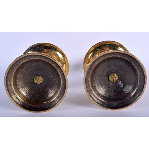 596 - A PAIR OF 18TH CENTURY EUROPEAN BRASS CANDLESTICKS with circular drip trays. 23 cm high.