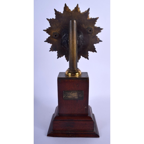 618 - AN ANTIQUE MASONIC BRASS STANDARD upon an oak plinth. 33 cm x 8 cm.