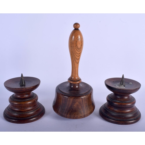 621 - A PAIR OF QUEEN ANNE STYLE TREEN PRICKET CANDLESTICKS and a mallet. Largest 18 cm high. (3)