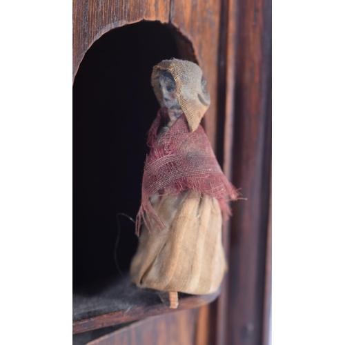 626 - A RARE 19TH CENTURY CONTINENTAL OAK CASED SPINNING AUTOMATON TOY. 25 cm x 16 cm.