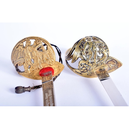 635 - A PAIR OF ANTIQUE MINIATURE SWORD LETTER OPENERS together with a miniature military cross. Largest 2... 