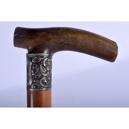 643 - A 19TH CENTURY CONTINENTAL CARVED RHINOCEROS HORN HANDLED WALKING CANE. 88 cm long.