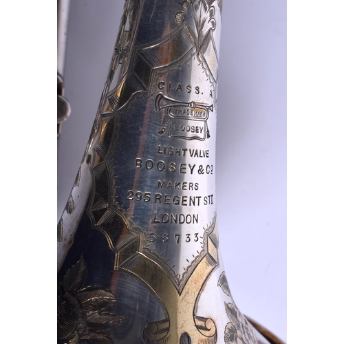 650 - A BOXED BOOSEY & CO TRUMPET decorated with foliage. 33 cm wide.