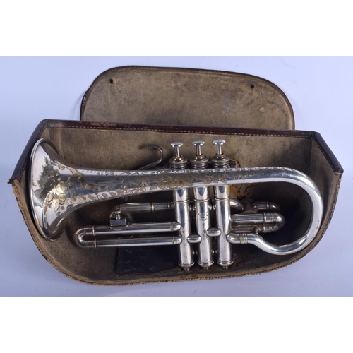 650 - A BOXED BOOSEY & CO TRUMPET decorated with foliage. 33 cm wide.