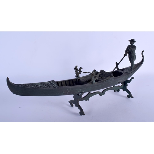 667 - AN EARLY 20TH CENTURY ITALIAN MODEL OF A GONDOLA modelled with a male holding an oar. 44 cm x 22 cm.