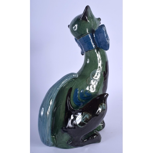 68 - A VINTAGE CHARLES BRANNAM POTTERY FIGURE OF A CAT modelled in a bowtie. 27 cm x 9 cm.