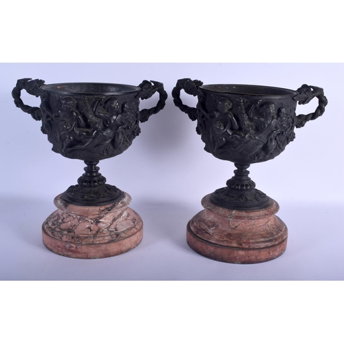 680 - A LARGE PAIR OF 19TH CENTURY EUROPEAN TWIN HANDLED BRONZE URNS decorated in relief with figures. 34 ... 