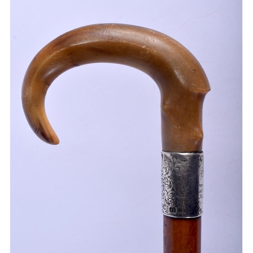 688 - A 19TH CENTURY CONTINENTAL CARVED RHINOCEROS HORN WALKING CANE with silver mounts. 88 cm long.