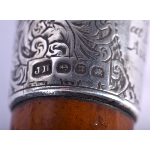 688 - A 19TH CENTURY CONTINENTAL CARVED RHINOCEROS HORN WALKING CANE with silver mounts. 88 cm long.