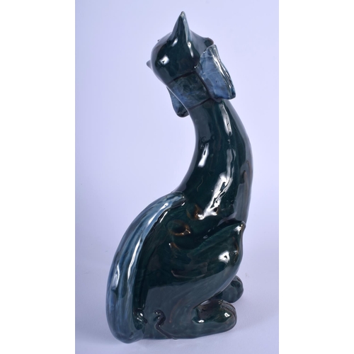 69 - A SMALLER VINTAGE CHARLES BRANNAM POTTERY FIGURE OF A CAT modelled in a bowtie. 21 cm x 7 cm.