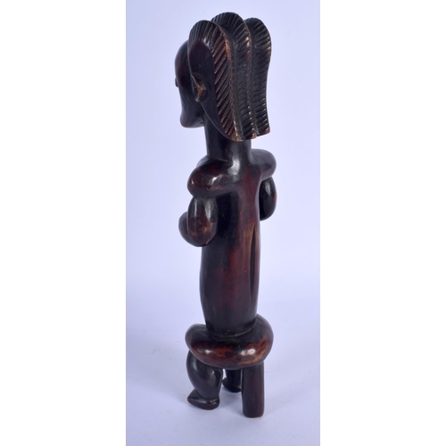 703 - AN EARLY 20TH CENTURY AFRICAN TRIBAL MUSCULAR FIGURE of good rich colour. 24 cm high.