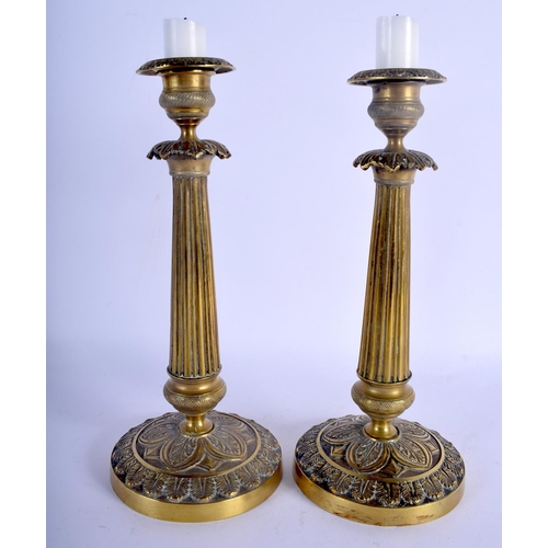 707 - A PAIR OF 19TH CENTURY FRENCH GILT METAL CANDLESTICKS Empire style. 25.5 cm high.