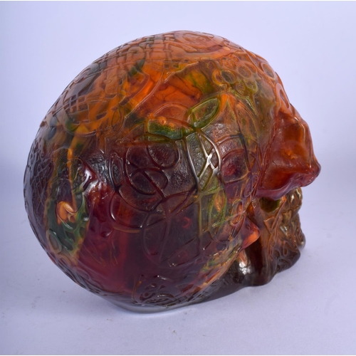 721 - A CONTEMPORARY AMBER TYPE SKULL. 16 cm x 14 cm.