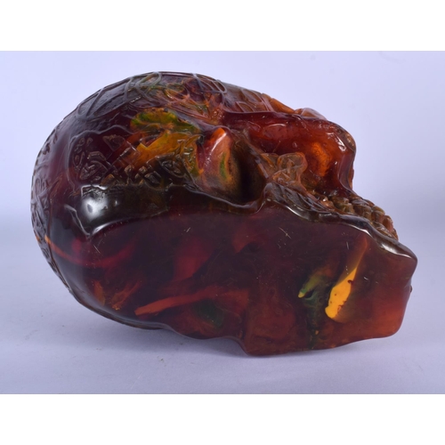 721 - A CONTEMPORARY AMBER TYPE SKULL. 16 cm x 14 cm.