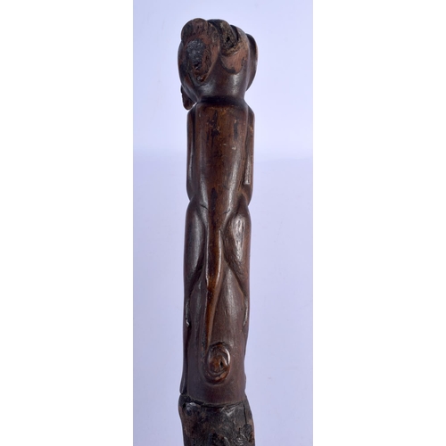 726 - AN ANTIQUE FOLK ART CARVED WOOD SHAMAN STYLE STICK possibly tribal. 88 cm long.