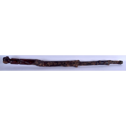 726 - AN ANTIQUE FOLK ART CARVED WOOD SHAMAN STYLE STICK possibly tribal. 88 cm long.