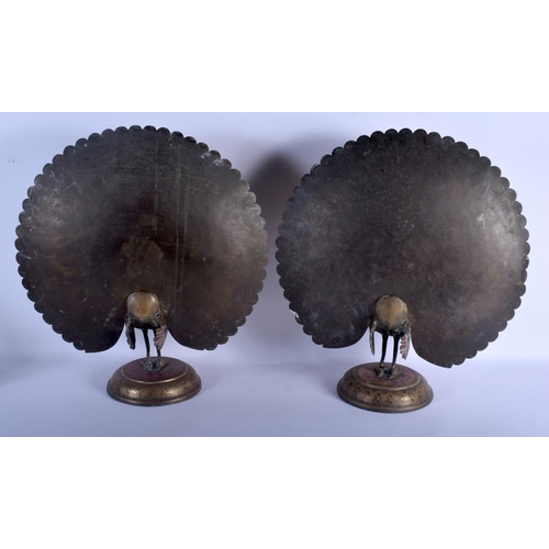 739 - A RARE LARGE PAIR OF EARLY 20TH CENTURY INDIAN ENAMELLED BRASS PEACOCKS upon circular bases decorate... 