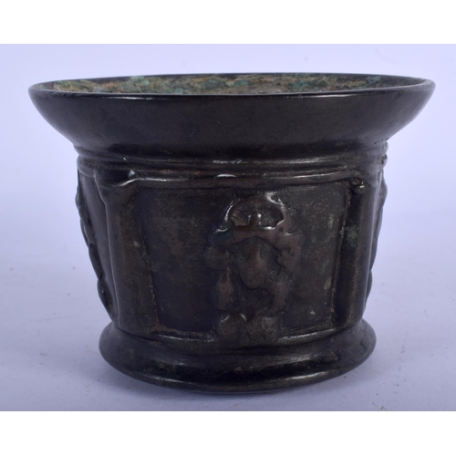 749 - AN EARLY CONTINENTAL BRONZE MORTAR decorated with motifs. 8 cm x 11 cm.