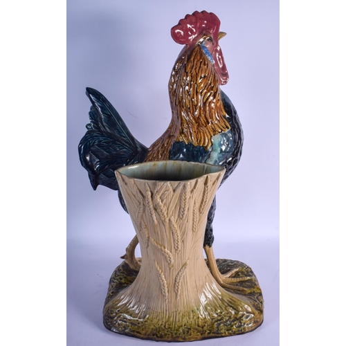 753 - A LARGE 19TH CENTURY CONTINENTAL MAJOLICA FIGURE OF A ROAMING COCK modelled upon a naturalistic base... 