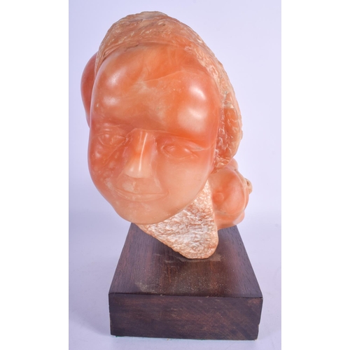 760 - AN UNUSUAL VINTAGE CARVED ORANGE HARDSTONE SCULPTURE OF TWO HEADS. Hardstone 24 cm x 19 cm.