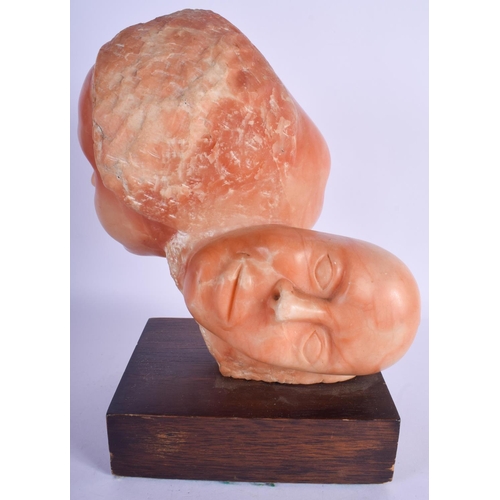 760 - AN UNUSUAL VINTAGE CARVED ORANGE HARDSTONE SCULPTURE OF TWO HEADS. Hardstone 24 cm x 19 cm.