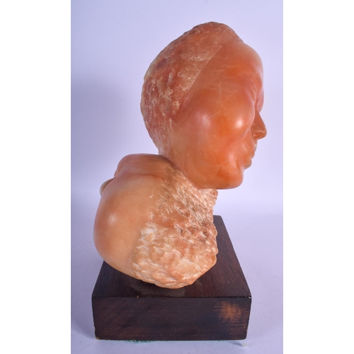 760 - AN UNUSUAL VINTAGE CARVED ORANGE HARDSTONE SCULPTURE OF TWO HEADS. Hardstone 24 cm x 19 cm.