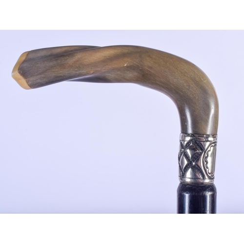 773 - A 19TH CENTURY CONTINENTAL CARVED RHINOCEROS HORN HANDLED WALKING CANE with silver mounts. 88 cm lon... 