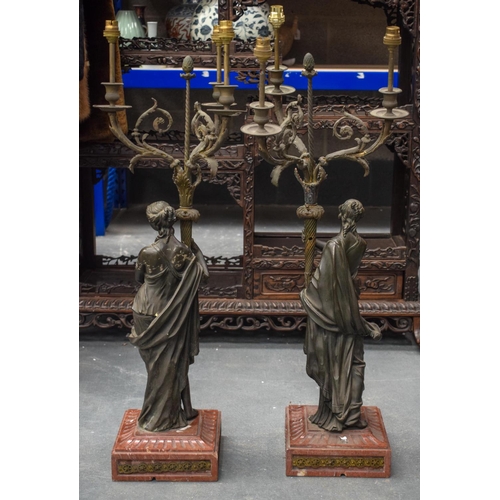 783 - A VERY LARGE PAIR OF 19TH CENTURY FRENCH BRONZE AND MARBLE CANDLESTICKS modelled holding aloft cornu... 