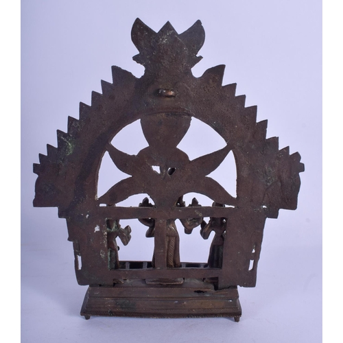 809 - AN 18TH CENTURY INDIAN HINDU BUDDHISTIC BRONZE SHRINE modelled standing in front of a floral plate. ... 