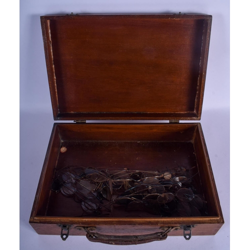 810 - A MINIATURE VINTAGE SUITCASE containing 34 pairs of spectacles. (35)