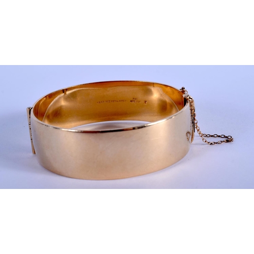 857 - A 9CT GOLD PLATED BANGLE. 52 grams. 6.5 cm x 5.5 cm.