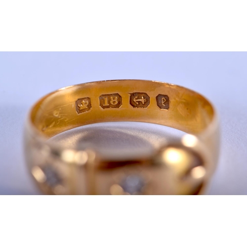 902 - AN 18CT GOLD AND DIAMOND BUCKLE RING. 3.7 grams. N.