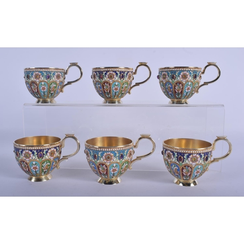 966 - A SET OF SIX CONTINENTAL SILVER AND ENAMEL CUPS AND SAUCERS decorated with foliage and vines. 1680 g... 