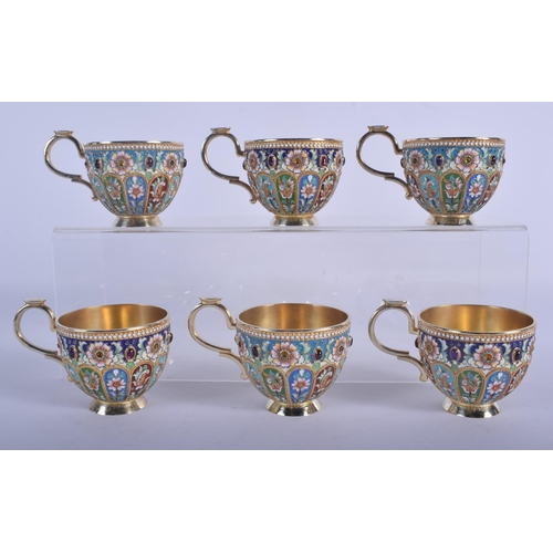 966 - A SET OF SIX CONTINENTAL SILVER AND ENAMEL CUPS AND SAUCERS decorated with foliage and vines. 1680 g... 